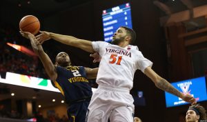 Dec 3, 2016; Charlottesville, VA, USA; West Virginia Mountaineers guard Jevon Carter (2) shoots the ball as Virginia Cavaliers guard Darius Thompson (51) defends in the first half at John Paul Jones Arena. Mandatory Credit: Geoff Burke-USA TODAY Sports